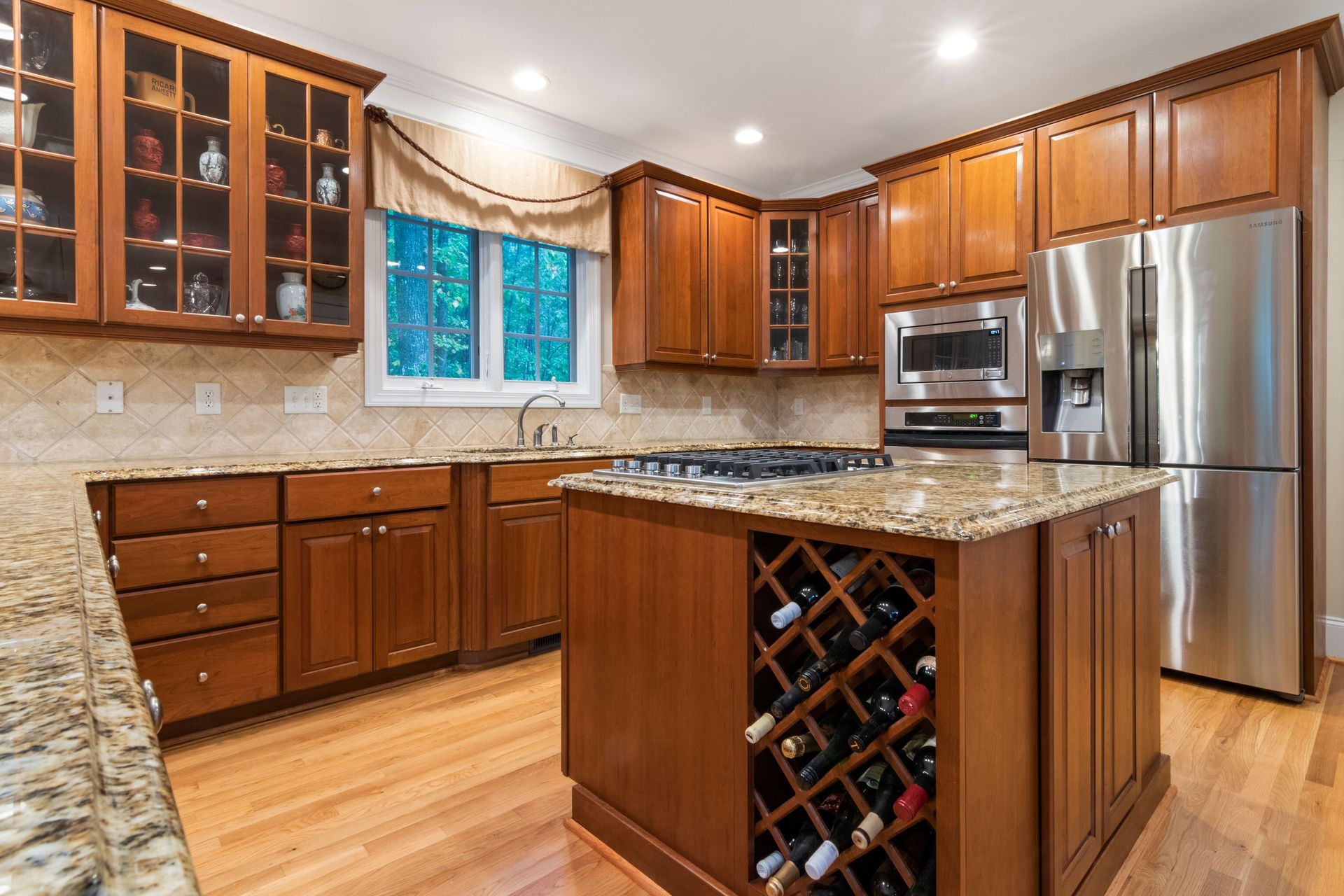 Stylish kitchen featuring wooden cabinetry, modern appliances, and granite countertops for a luxurious feel.